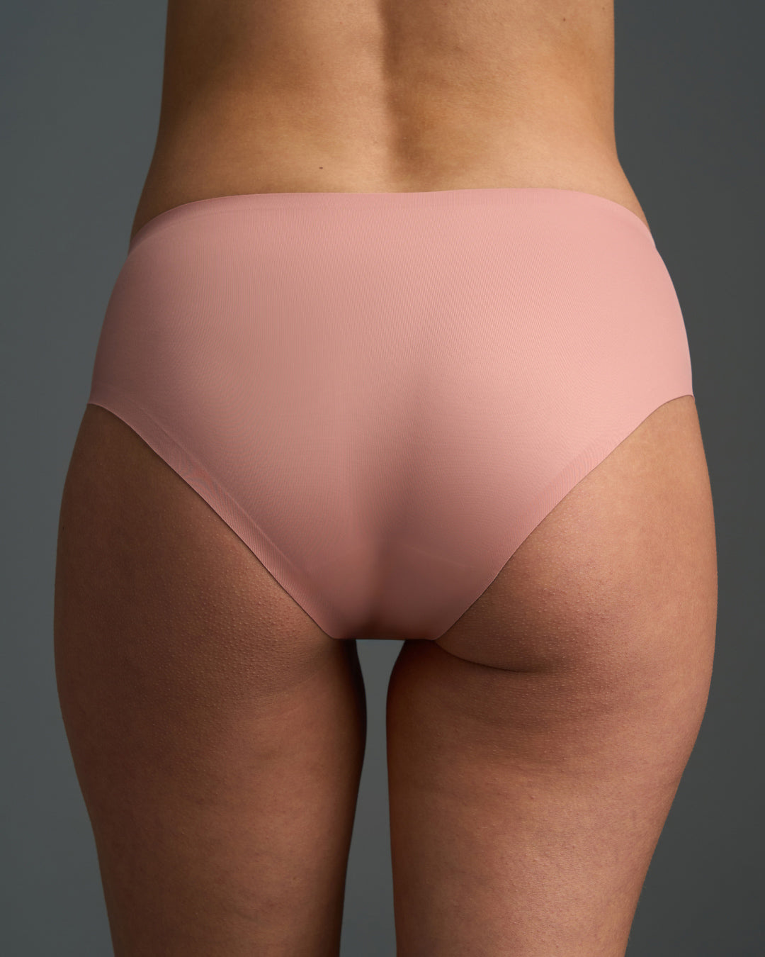 Ash Rose panties worn by a person on a gray background