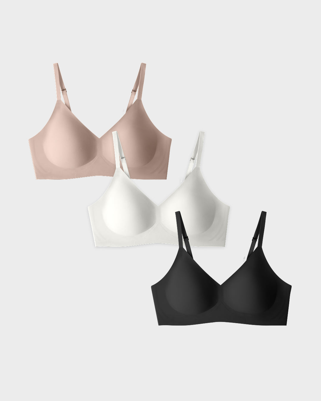 Three relief bras in black, white, and beige on a light gray background