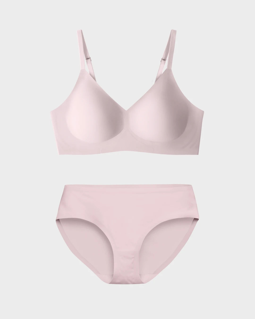 Blush pink seamless scoop-neck bralette and matching hipster briefs flat lay on white background