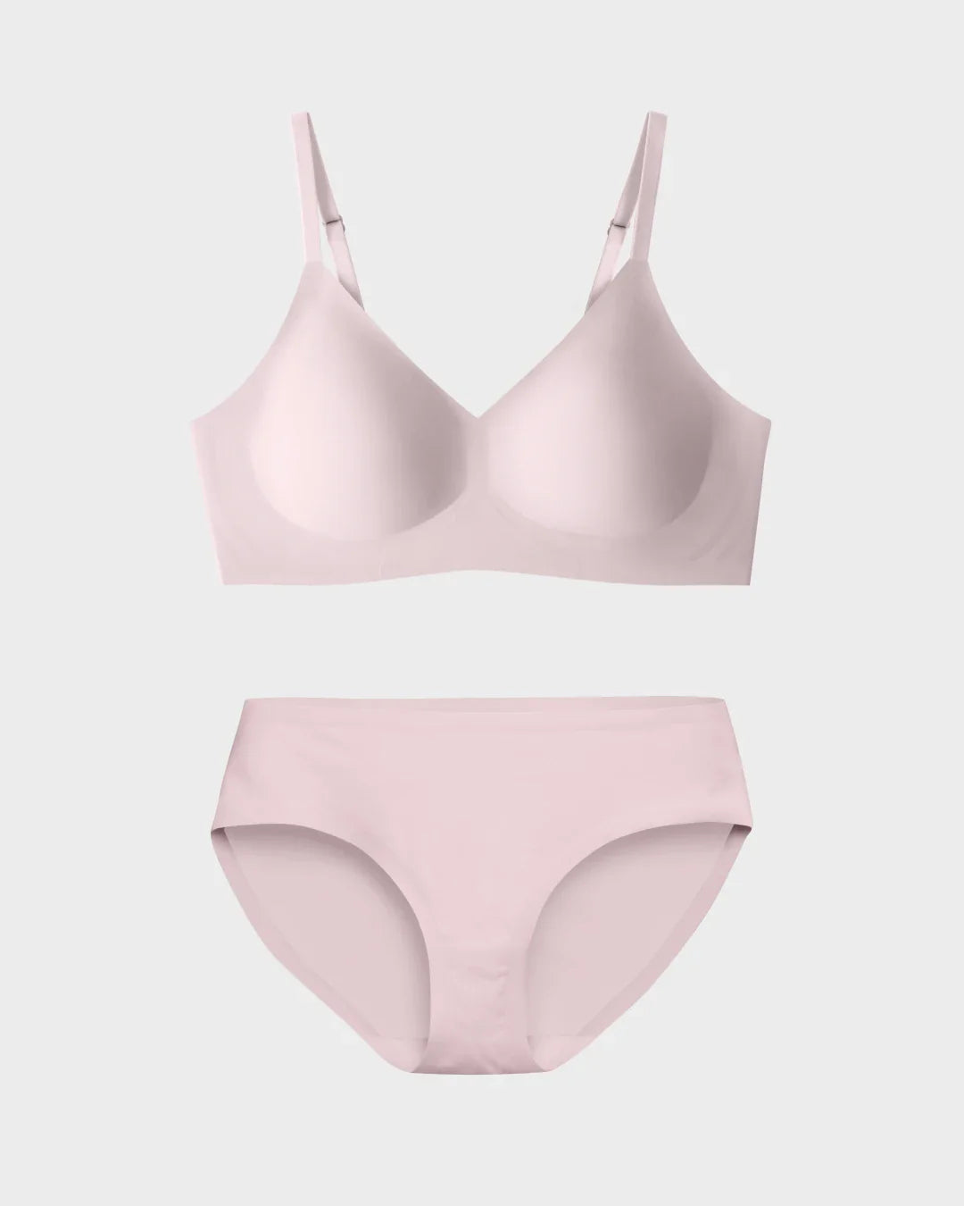 Blush pink seamless scoop-neck bralette and matching hipster briefs flat lay on white background
