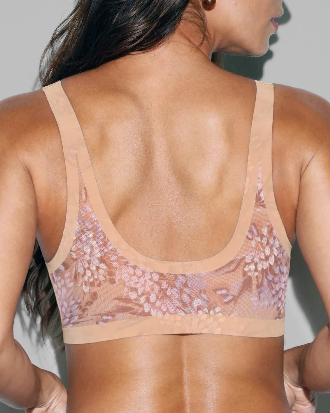 Back view of sheer wisteria floral plunge bralette showing the low scoop back and wide printed mesh straps.