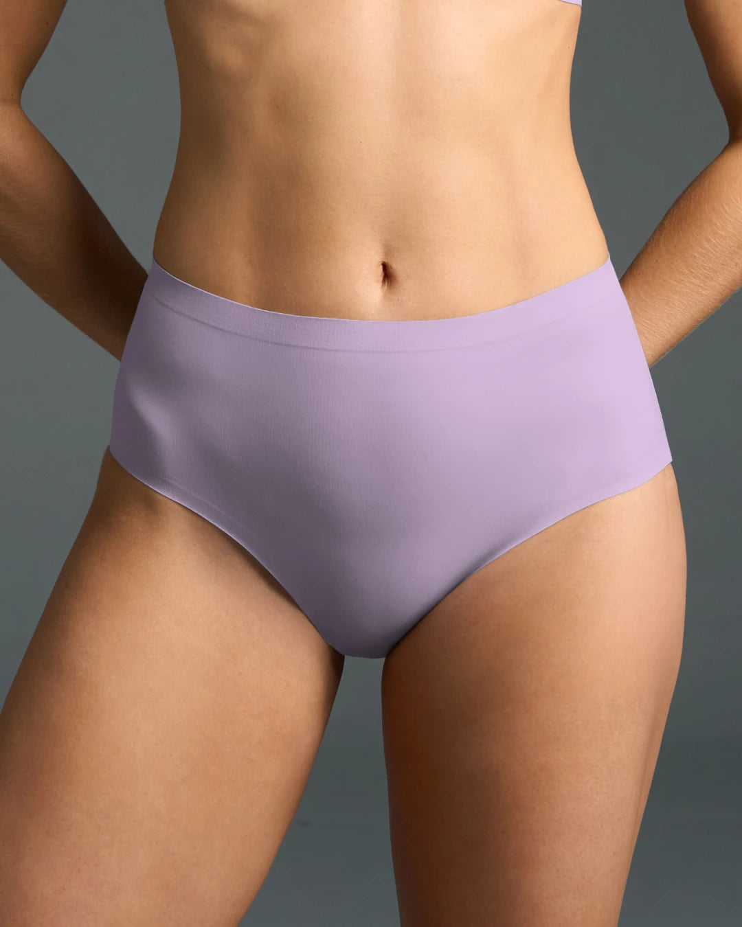 Lilac high rise no show panties shown on model, featuring seamless edges, smooth stretch fabric, and a flattering high waist for invisible comfort under clothing